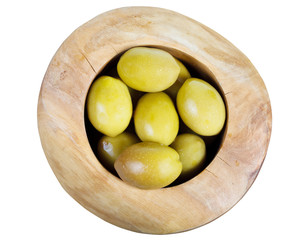 above view of green olives in wooden bowl isolated