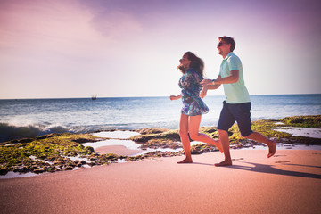 couple running at the beach