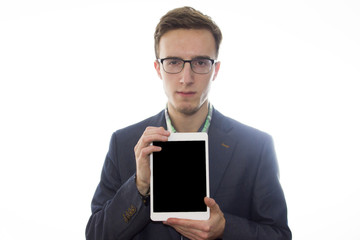 Serious young man presenting a tablet or iPad.