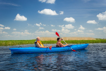 Couple kayaking on river