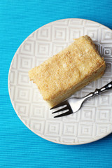 Napoleon cake on plate on table close-up