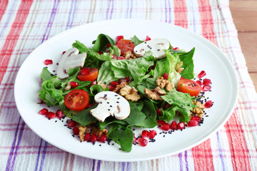 Fresh salad with greens, garnet and spices