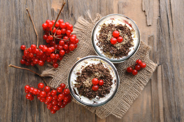 Delicious dessert in jars on table close-up