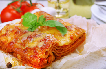 Portion of tasty lasagna on table