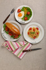 Menu of day. Plates with food on table