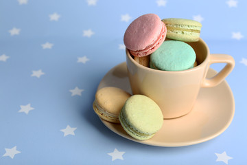 Assortment of gentle colorful macaroons in colorful mug