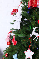 Fototapeta na wymiar Knitted Christmas angels on Christmas tree, close-up