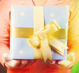 Gift box in female hand close-up