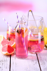 Pink lemonade on table on bright background close-up