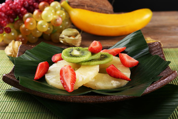 Fruit dessert on green leaf on table