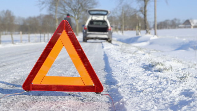 Winter Driving - Car Trouble - Woman calling roadside assistance