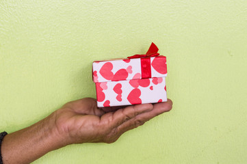 Female hand holding gift box