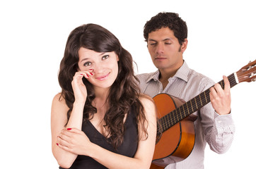 Obraz na płótnie Canvas handsome young man with guitar serenading beautiful girl