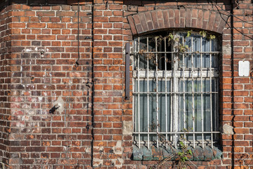 Fototapeta na wymiar Forgotten building with bars on the window