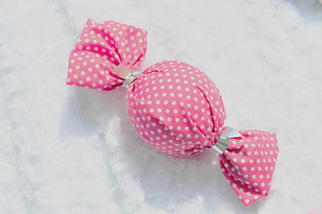 Place a piece of candy wrapped in pink coat