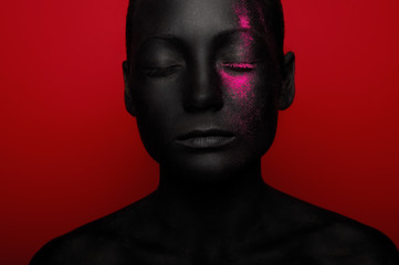 close-up portrait of woman in black paint