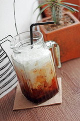 close up cold cappuccino on wooden table