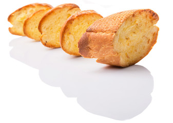 Homemade garlic bread of French baguette over white background