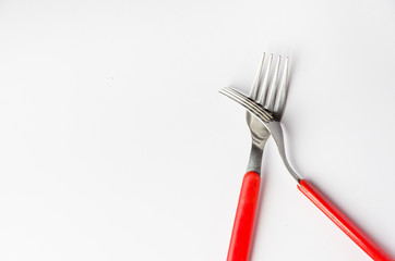 one fork atop another