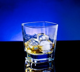 whiskey glass on light tint blue disco