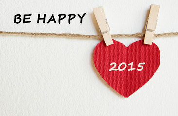 Red fabric heart with happy new year 2015 word background