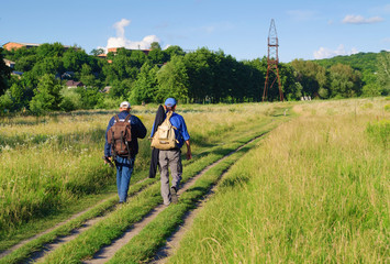 Two men with backpacks travel path