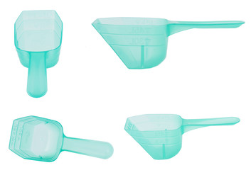 Green plastic measuring spoon on white background