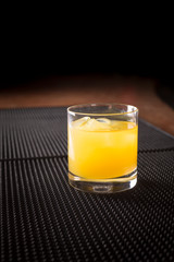 Screw driver cocktail on a bar ribber mat