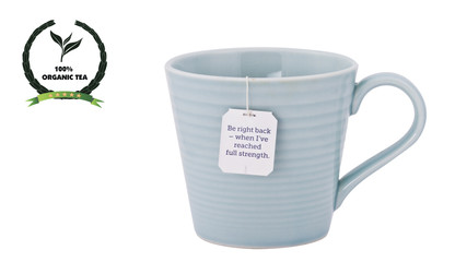 Tea cup, tagged tea bag with an organic label isolated on white