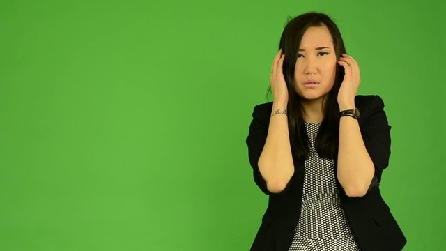 young attractive asian woman is afraid - green screen