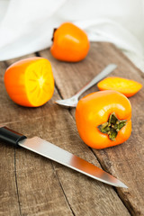 Fresh ripe persimmon on a wooden table