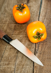 Fresh ripe persimmon on a wooden table