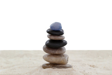 Balanced pebbles on sand