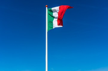 Italian flag on the blue sky