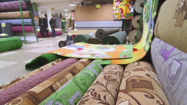 Customers looking for new rug in carpet store
