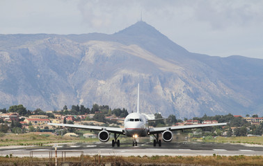 Plane on runway and mountains. Corfu, Greece