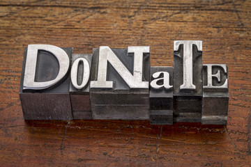 donate word in metal type