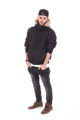Fototapeta premium Handsome young guy wearing jacket and black cap with her hands o