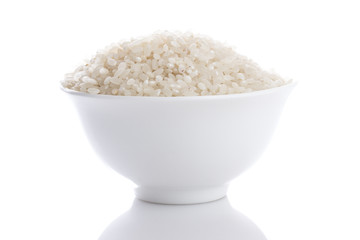 Grains of rice in a bowl isolated on white background.