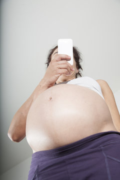 big tummy woman watching smartphone