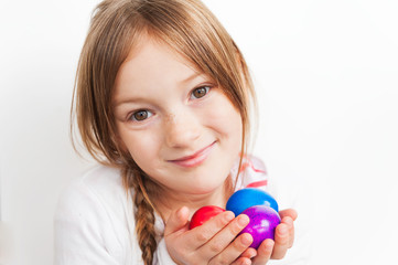 Close up of a little girl holding easter eggs