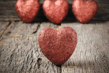 Fototapeta na wymiar Hearts on Vintage Wood Background for Valentine's Day