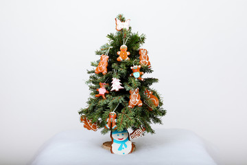 The New Year tree and hand-made cookies with snow decoration