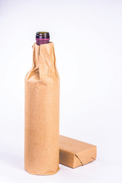 One Bottle Wrapped In Paper With The Box