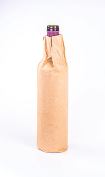 isolated one bottle wrapped in paper