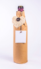 bottle wrapped in paper with decorative heart and blank card