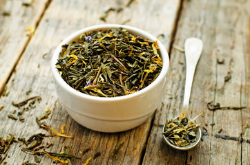 Fototapeta na wymiar green tea with flowers in a white bowl