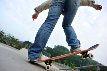 Fototapeta na wymiar skateboarding legs at skatepark