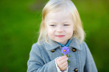 Adorable girl holding a flower