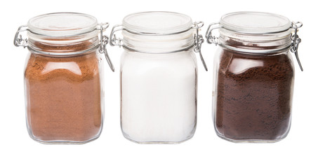 Instant coffee, chocolate drink powder and sugar in glass jar 